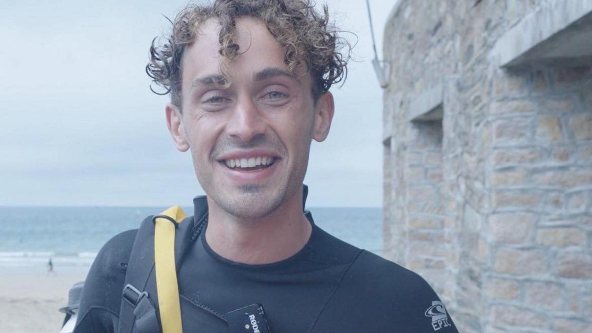 Martin Marescaux smiling at the camera. He has wet hair and is wearing a wetsuit.