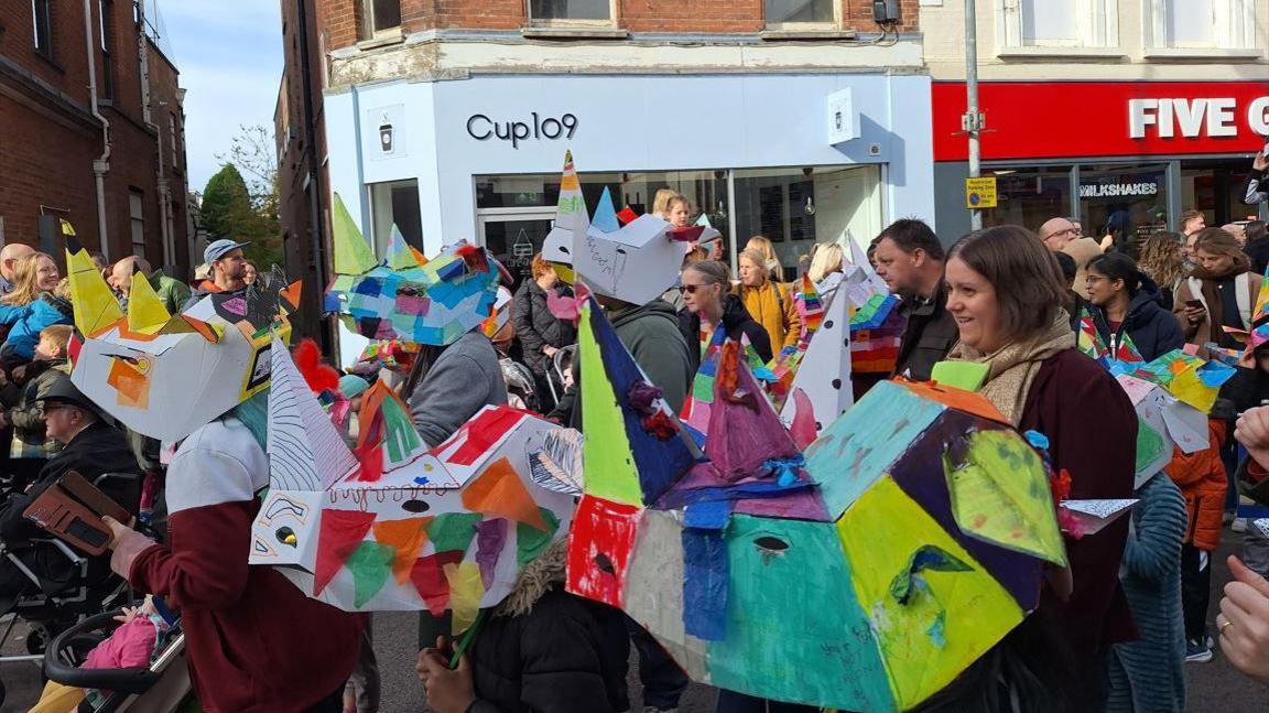 Children in rhino costumes taking part in puppet festival