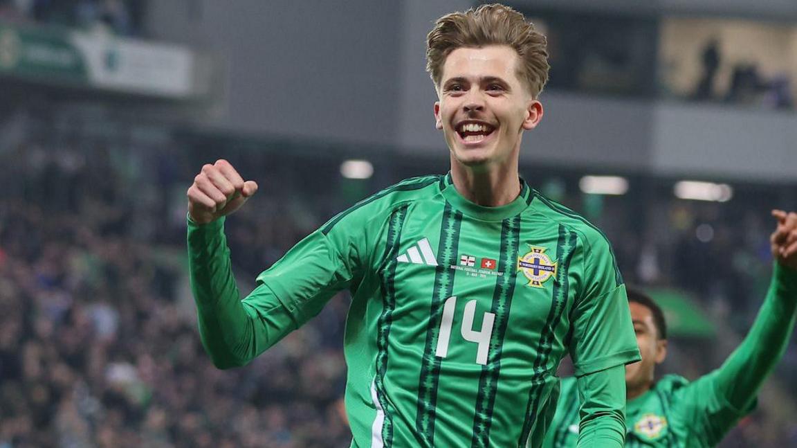 Isaac Price celebrates scoring against Switzerland