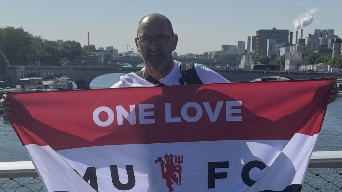 Manchester United fan James with a flag