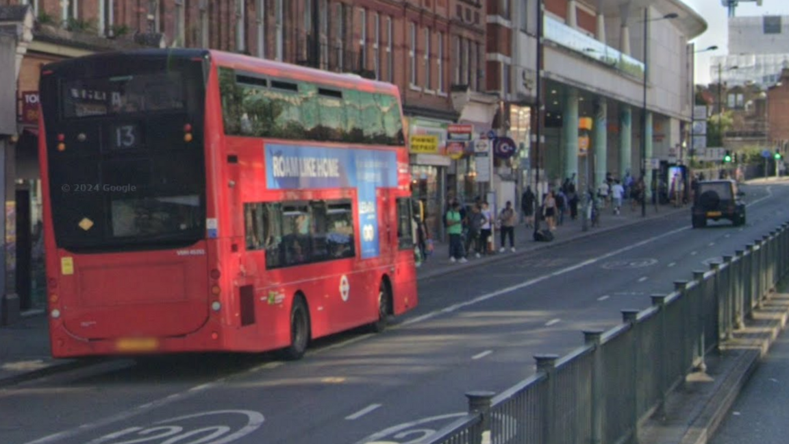  A route 13 red bus shown pulled over at Finchley Road