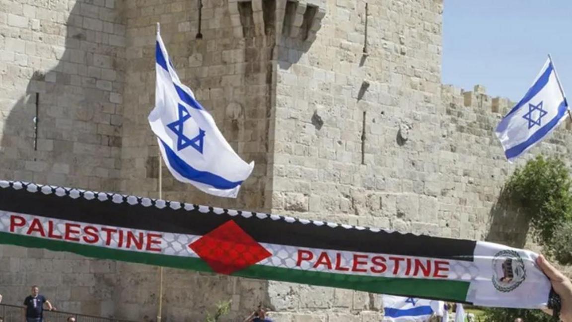 Israel flags and Palestine banner held aloft.