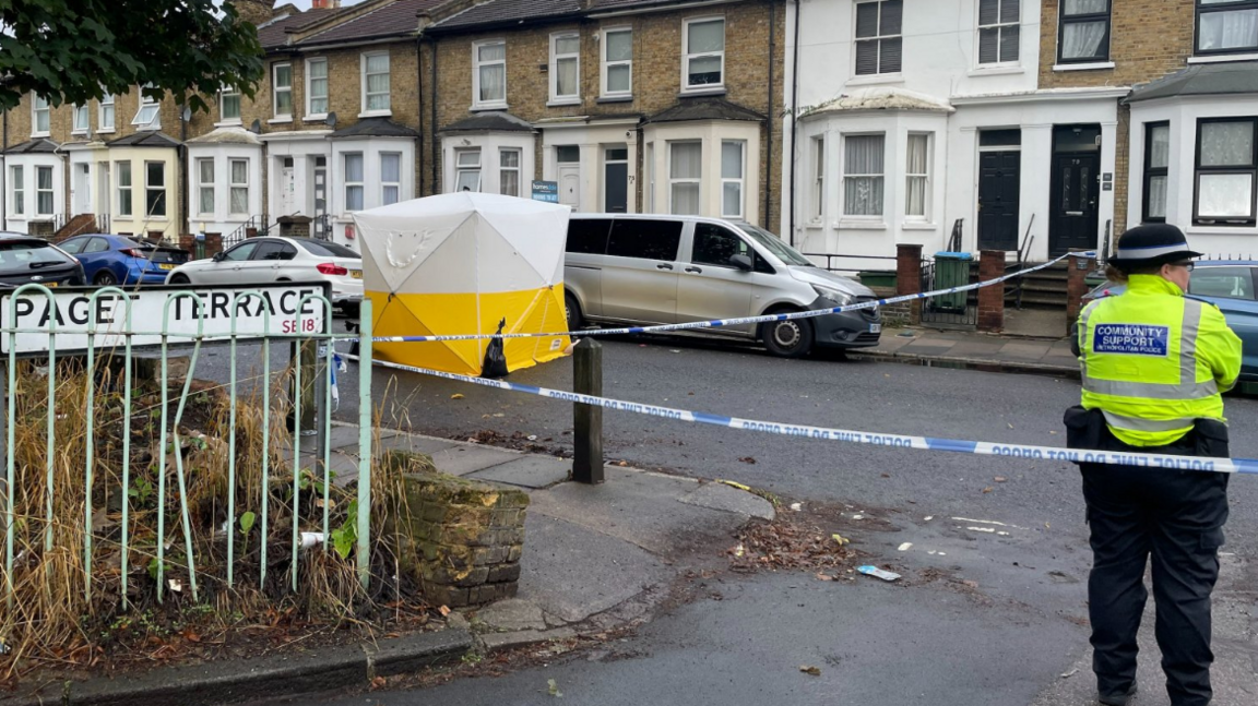 A Metropolitan Police officer stands near a police cordon and forensic tent on Paget Terrace, near the scene in Eglinton Road, Woolwich, south-east London, where a teenage boy was stabbed to death.