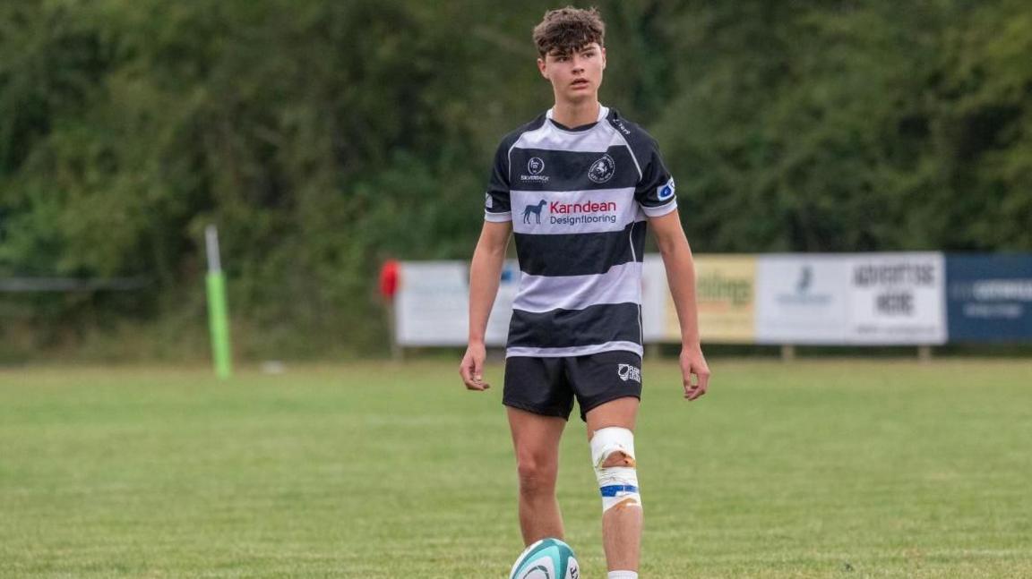 Harvey Luney playing rugby on a pitch