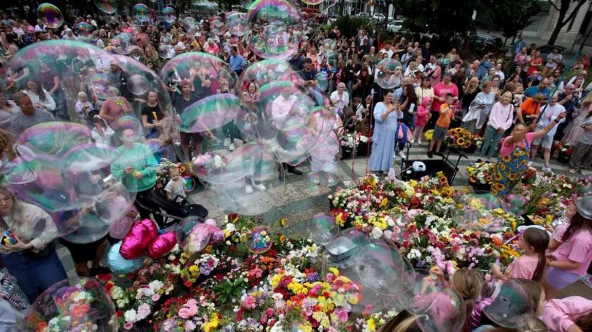 Thousands of people gathered in front of Southport Town Hall to show support to the families affected in the wake of the Southport knife attacks - laying flowers, blowing bubbles and leaving tributes.