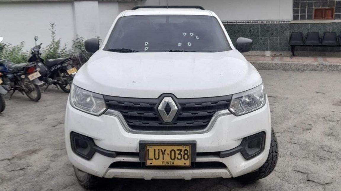 The bullet holes are visible in the windscreen of Jesús Cometa's white Renault car after an attempt on his life.