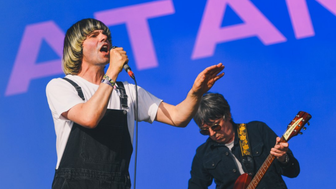Tim Burgess, wearing a white T-shirt and black dungarees and sporting his long blond basin haircut, sings on stage as The Charlatans perform on The Other stage at Glastonbury six years ago.