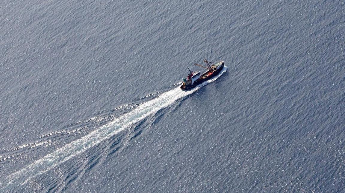 An aerial shot of a fishing boat at sea