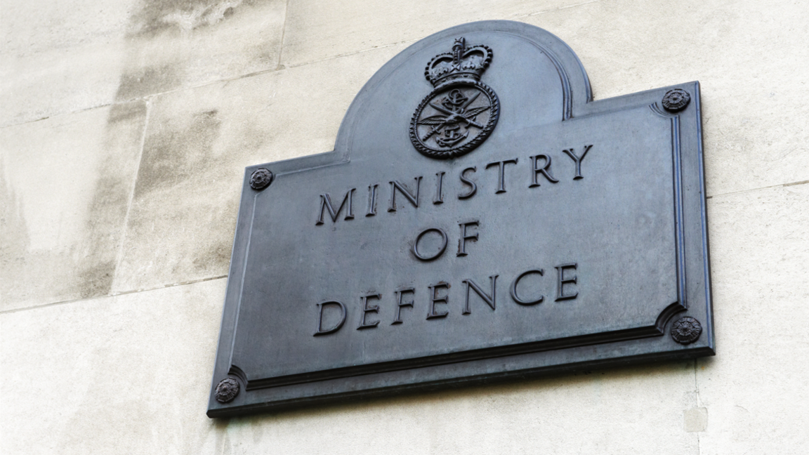 A plaque on the outside of the Ministry of Defence building bearing the ministry's name and its coat of arms