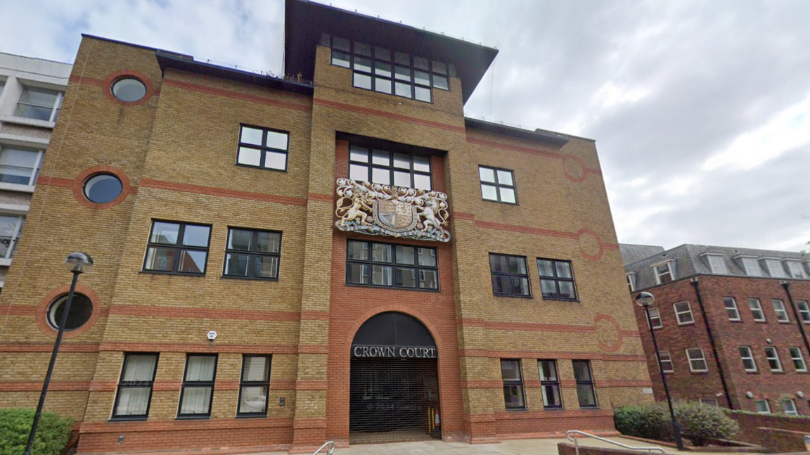 A general view picture of St Albans Crown Court, a four-storey brick building with a sign that says "crown court" above the front door.