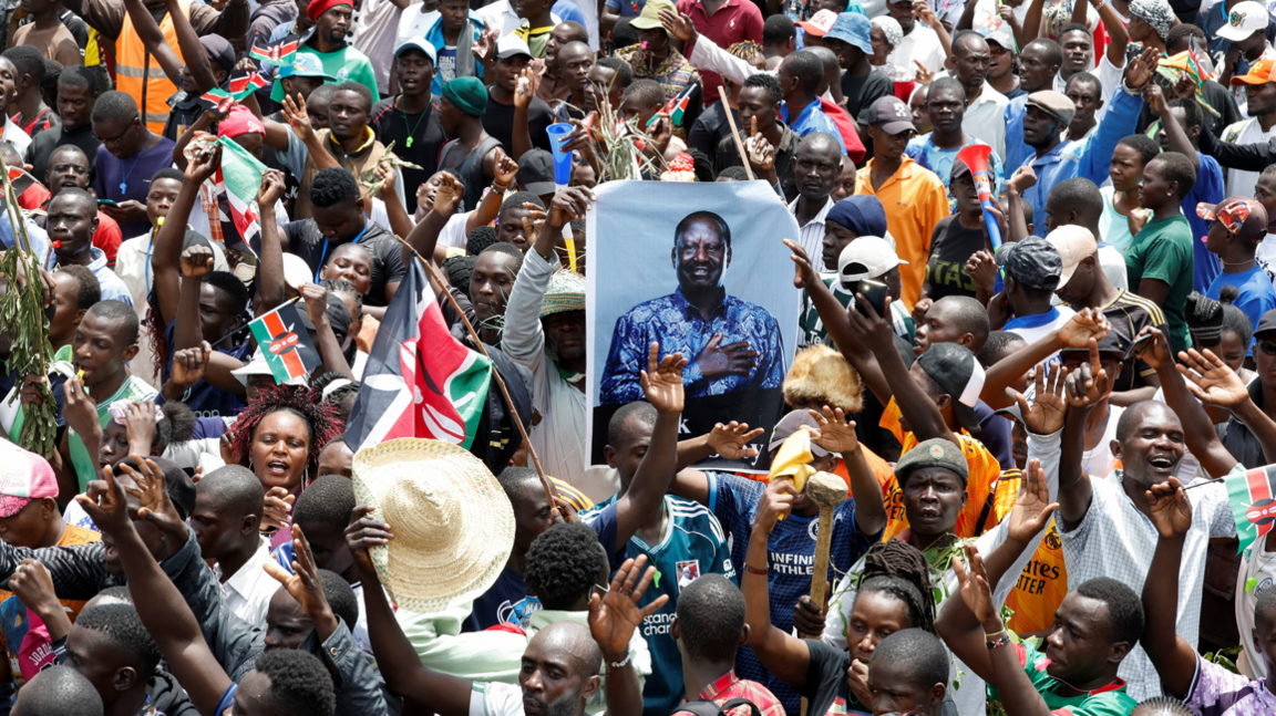 Mourners gather near a poster of late former Kenyan Prime Minister Raila Odinga, during his funeral service, at Jomo Kenyatta Stadium in Mamboleo, in Kisumu County, Kenya