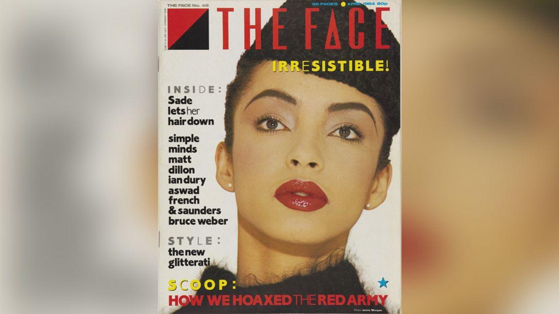 Front cover of The Face magazine showing Sade with a black hat and deep red lipstick. The Magazine description says: "Sade lets her hair down" and "Simple Minds, Matt Dillon, Ian Dury, Aswad, French & Saunders and Bruce Weber." It also says "Style: The new glitterati". 