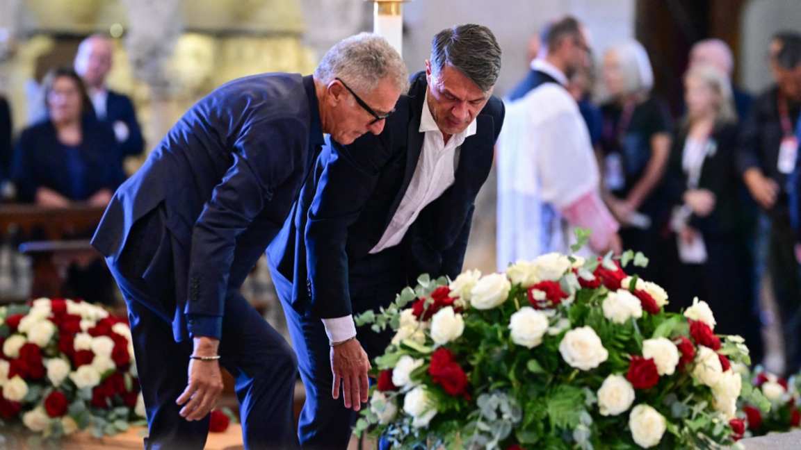 Former AC Milan and Italy defenders Mauro Tassotti and Paolo Maldini lay flowers at Franco Baresi's funeral