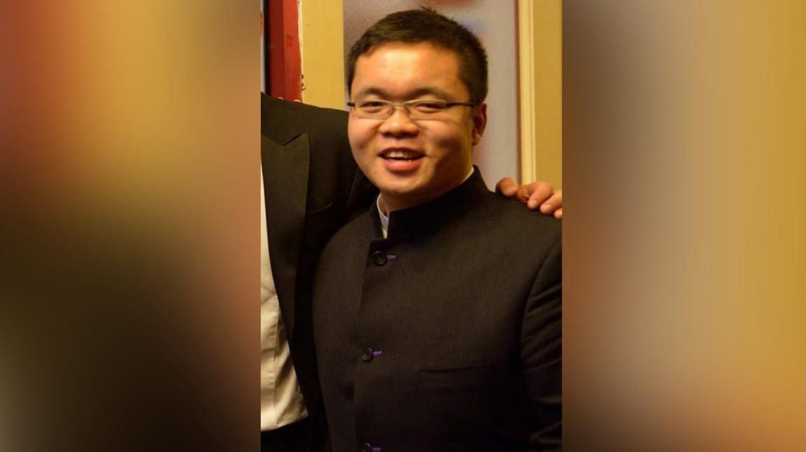 Peter Cui in a smart black jacket, shown during university days