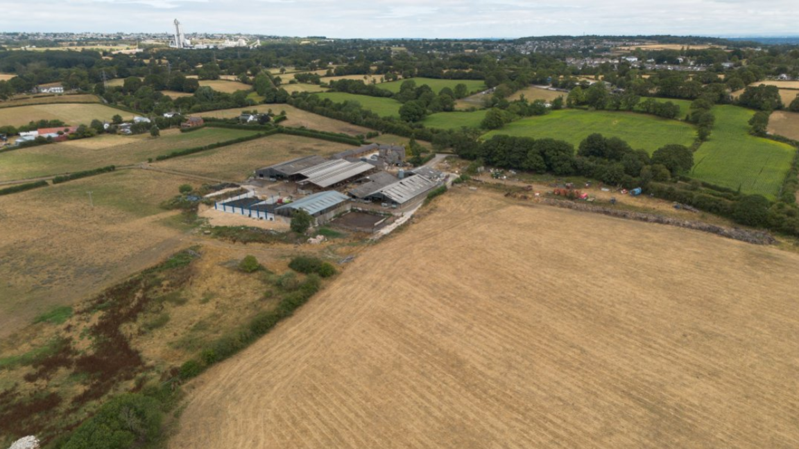 An aerial photograph taken with a drone of dry farmland in Penyffordd, Wales.