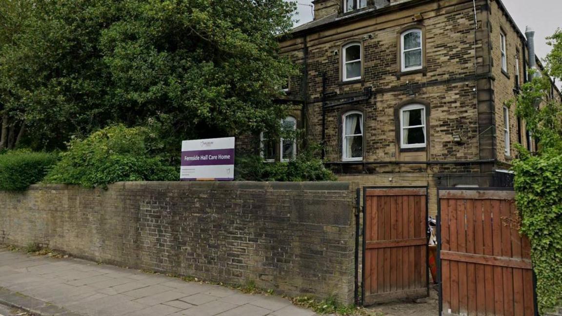 An exterior view of Fernside Hall. All that can be seen is an entrance sign and a three storey building in the background.