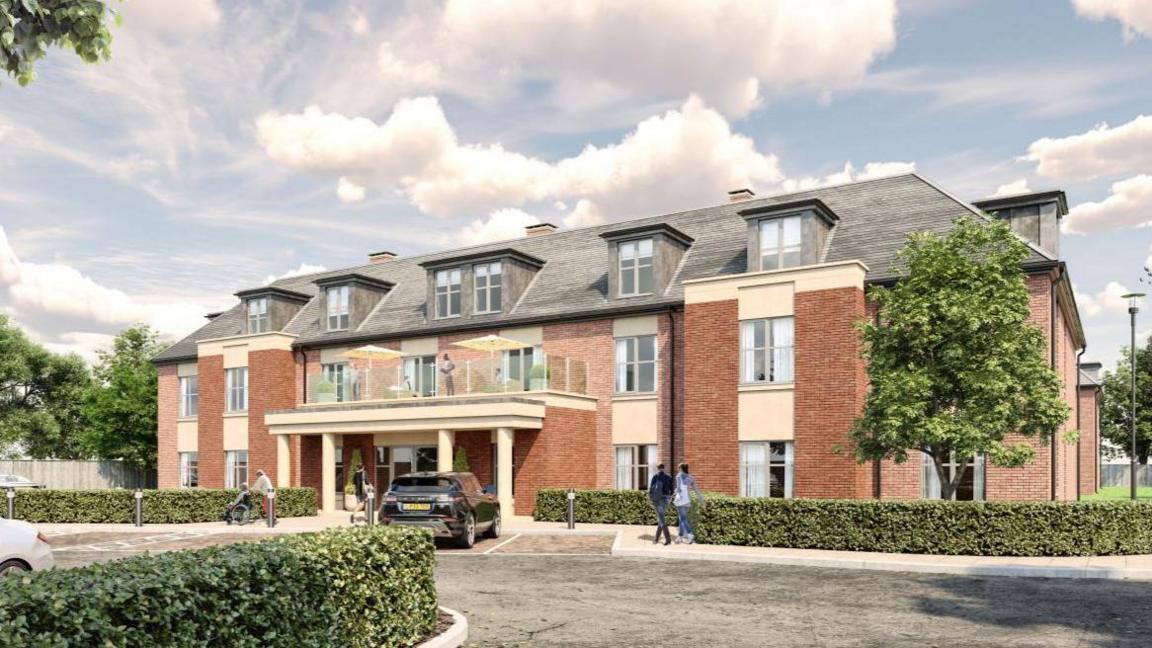 CGI generated image of a two-and-a-half story, red brick building with central glass balcony. A black car is parked in front of it in a parking bay and there are people walking around out the font, on is in a wheelchair.