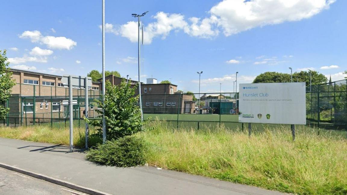 Exterior short of Hunslet Club with sign outside.