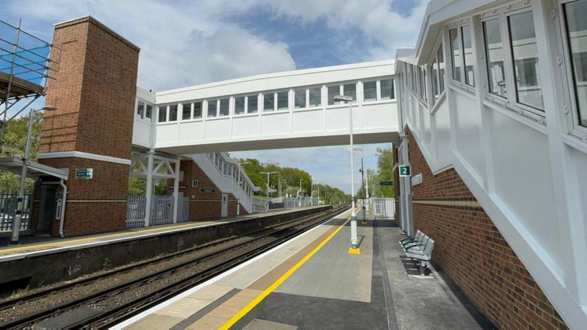 A white and brick railway station.