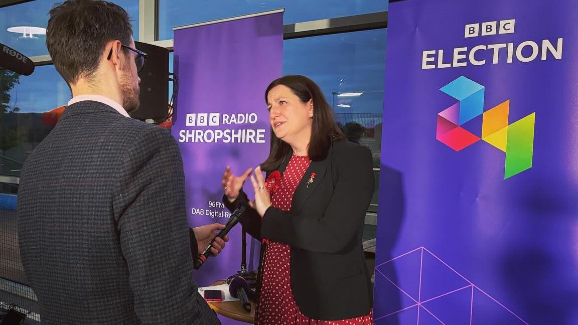 Julia Buckley being interviewed after the election result by BBC Radio Shropshire, with BBC branded banners behind her