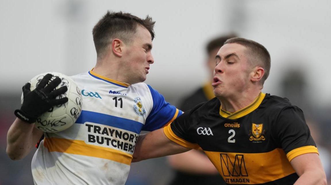 Dr Crokes' corner-back Evan Looney attempts to halt Ruairi Canavan at Newbridge