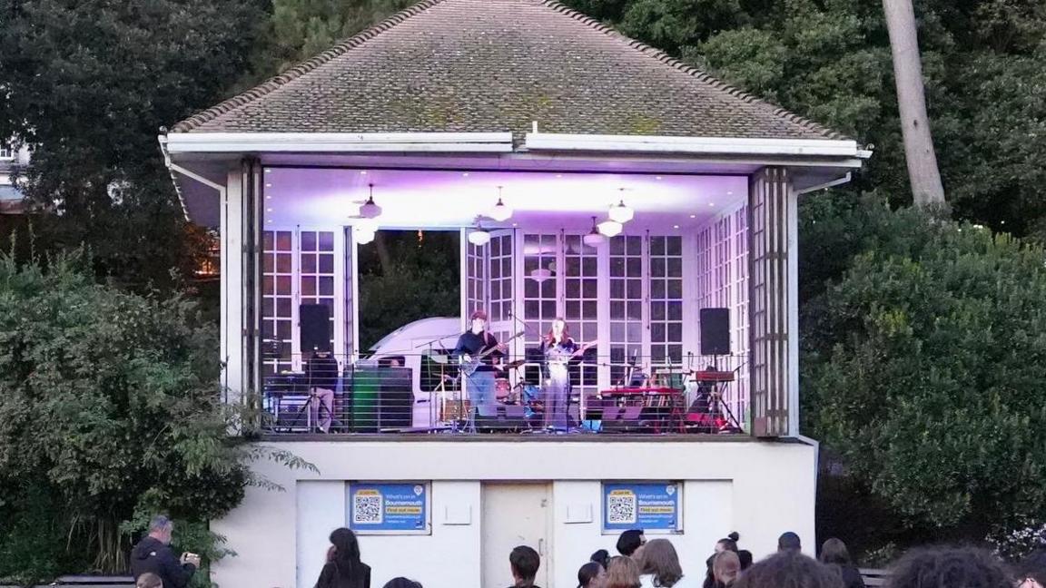 Crowds gathering to watch live music on a stage