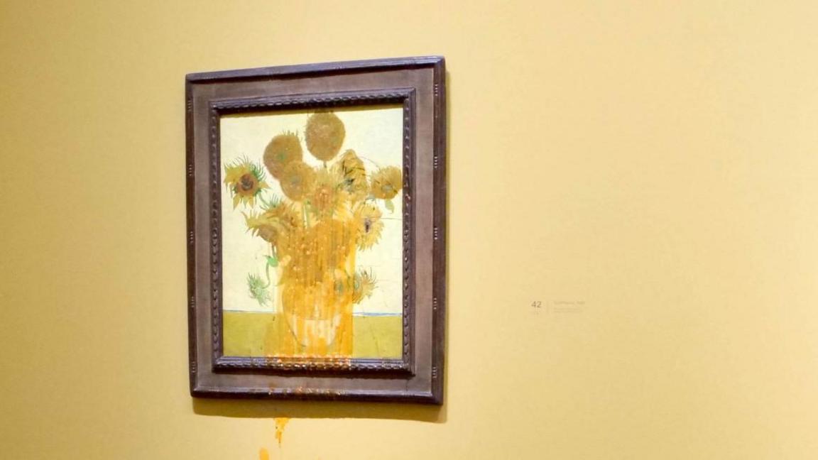 Van Gogh's Sunflowers with orange-coloured soup dribbling down it