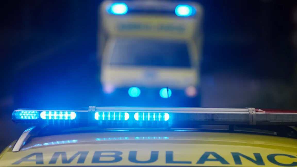 The top of an ambulance with its blue lights flashing