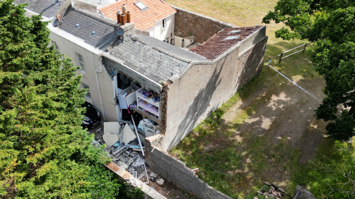 Aerial view of a house damaged in an incident in Jersey