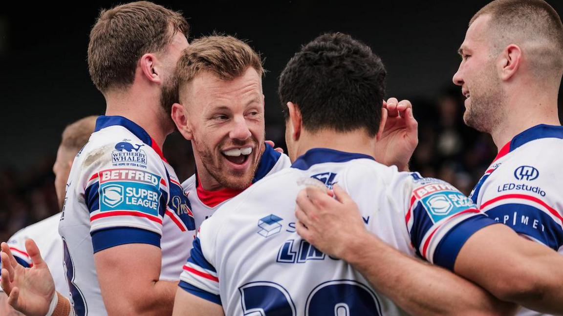 Tom Johnstone celebrates try with half back Mason Lino and team-mates