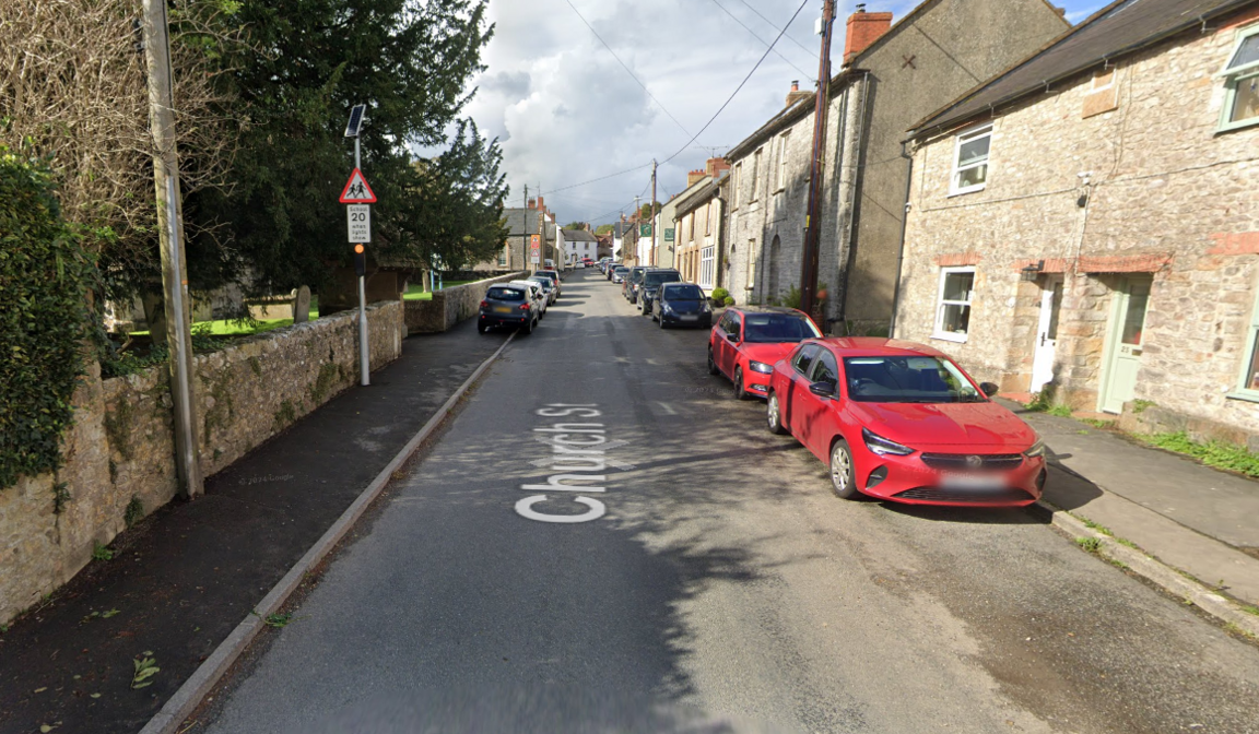 Church Street in Winsham, Somerset, seen from a Google street view camera, with cars parked in front of houses along one side