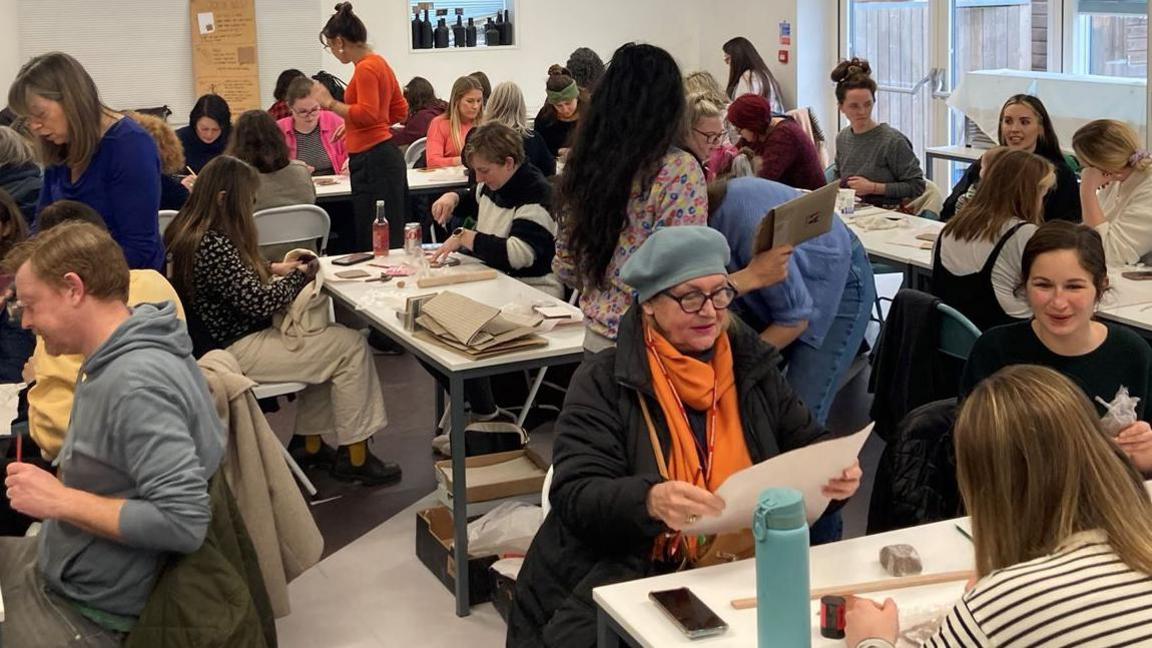 A busy room full of people creating tiles - the first workship in 2023 for Thanet Tiles of Joy project 