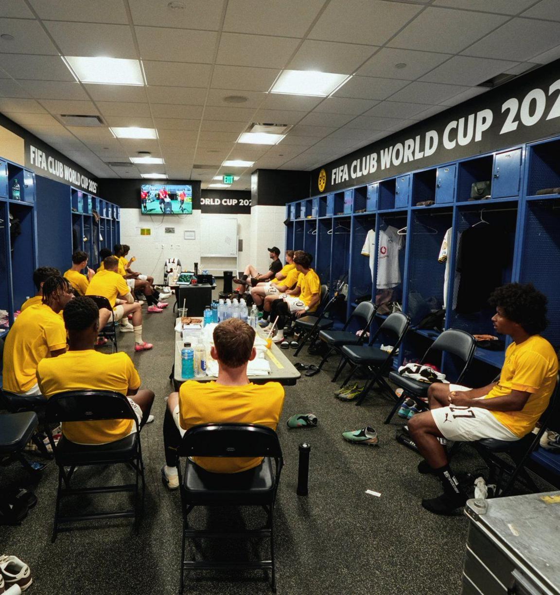 Dortmund players watching the game from the changing rooms