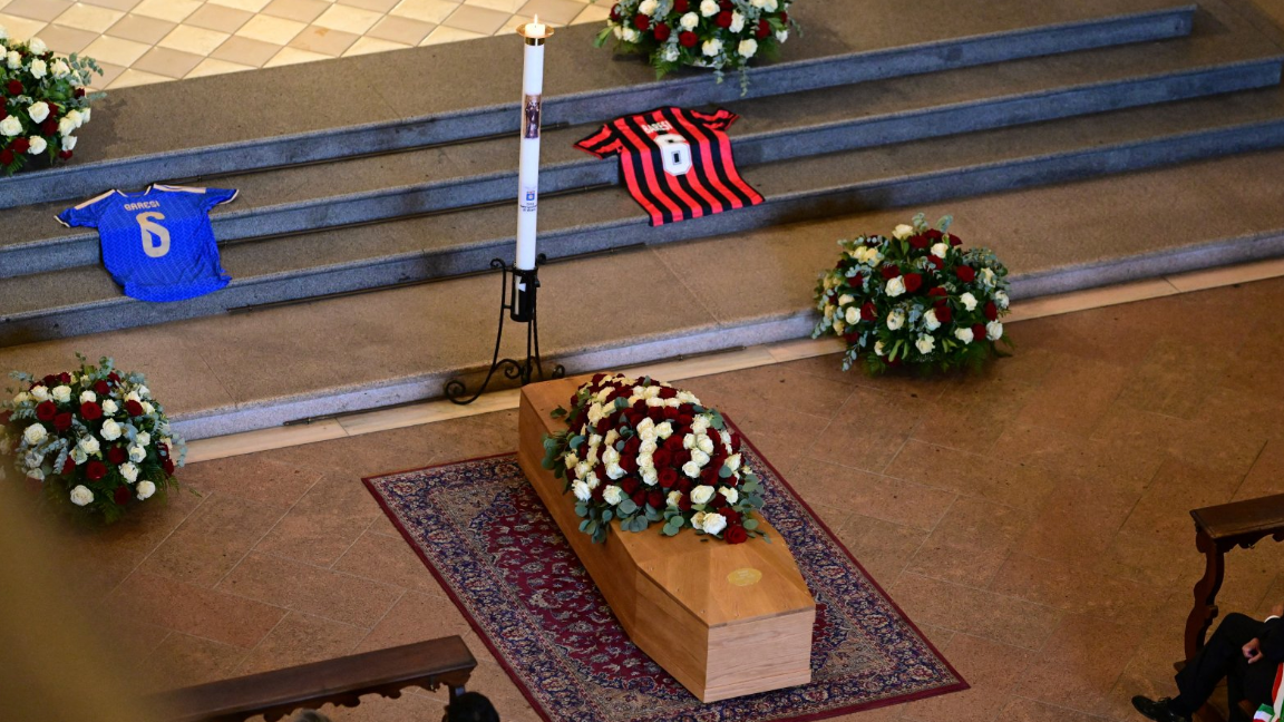 A picture of Franco Baresi's coffin with Italy and AC Milan shirts bearing his number six placed next to it