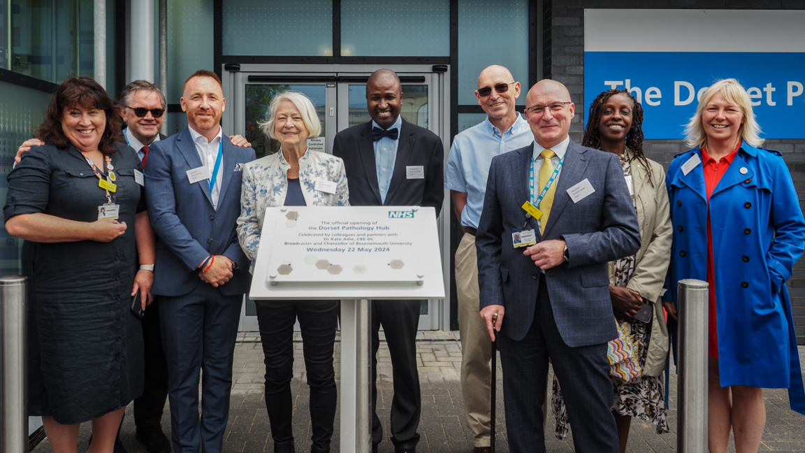 Kate Adie and NHS staff stand at entrance of new pathology centre