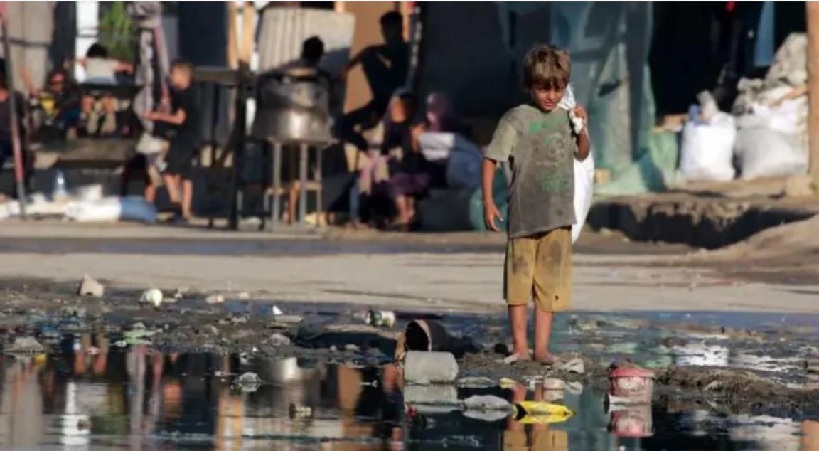 a child walking next to dirty water