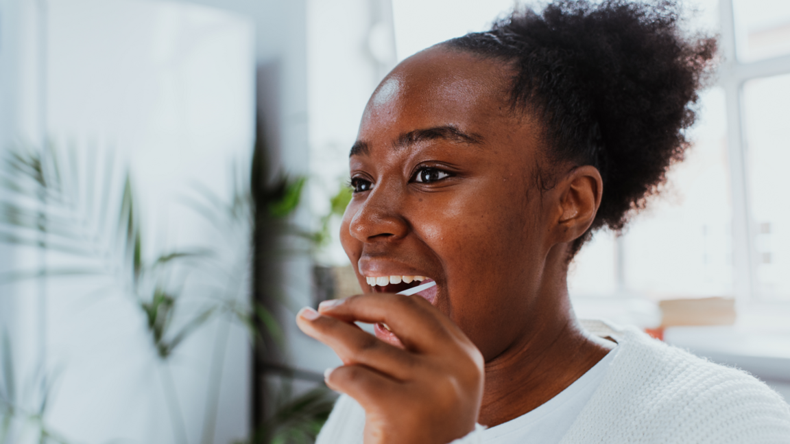 A woman swabs her mouth