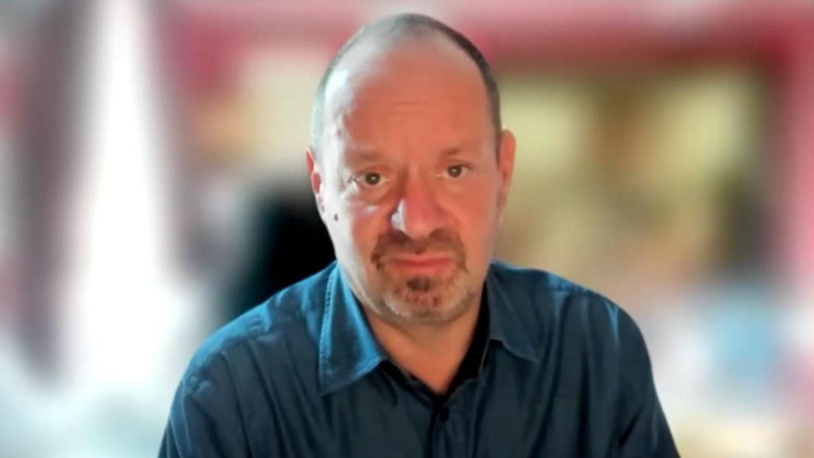 Prof Philippe Sands KC wears a blue shirt in a video call with the BBC