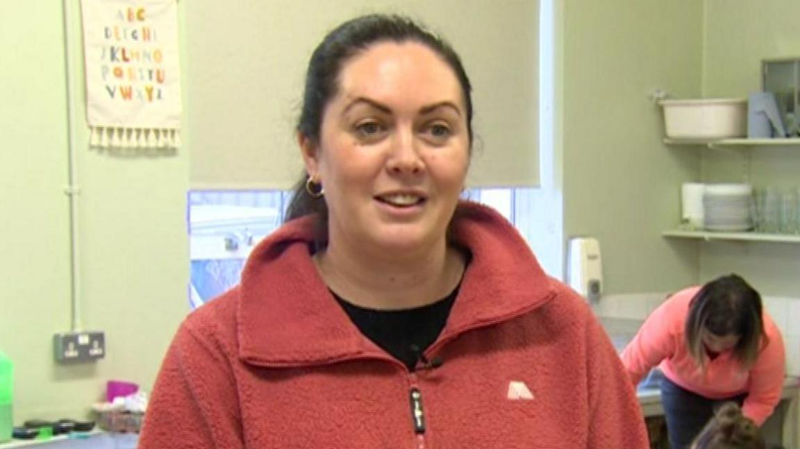 Danielle McKenna in Clogher Valley Sure Start. She is wearing a pink fleece and black t-shirt. 