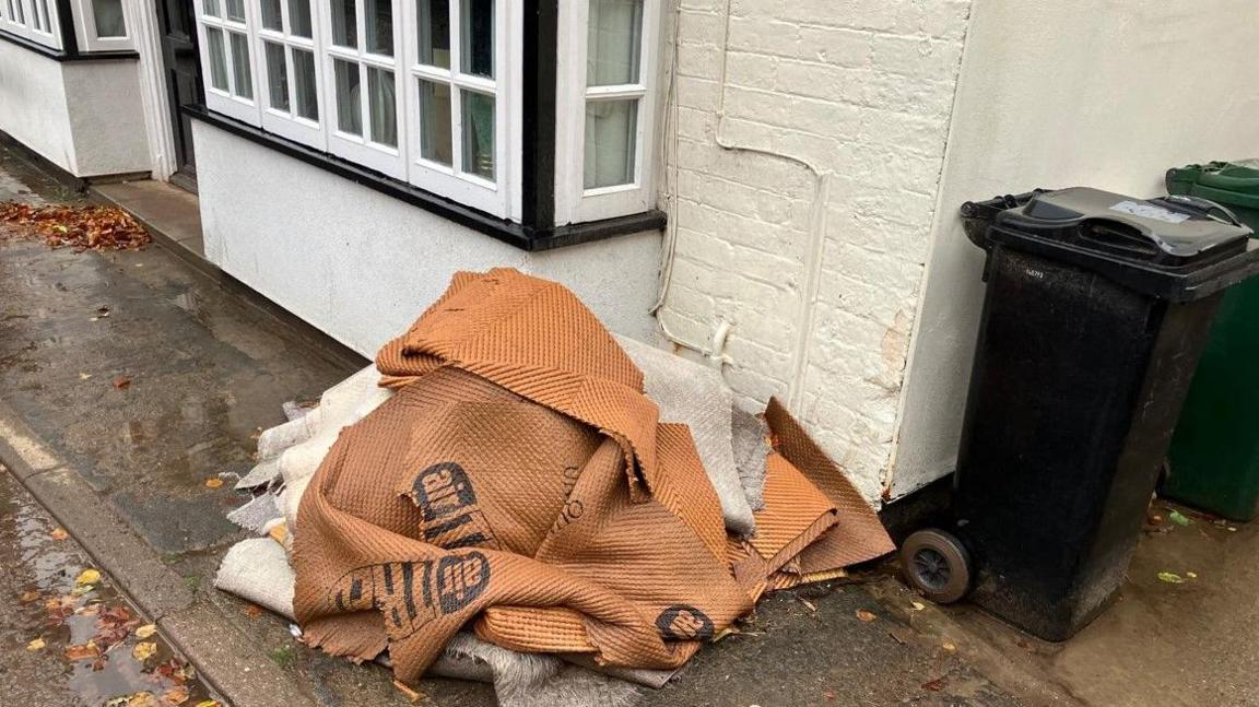 Affected carpet, brown and white, outside a home 