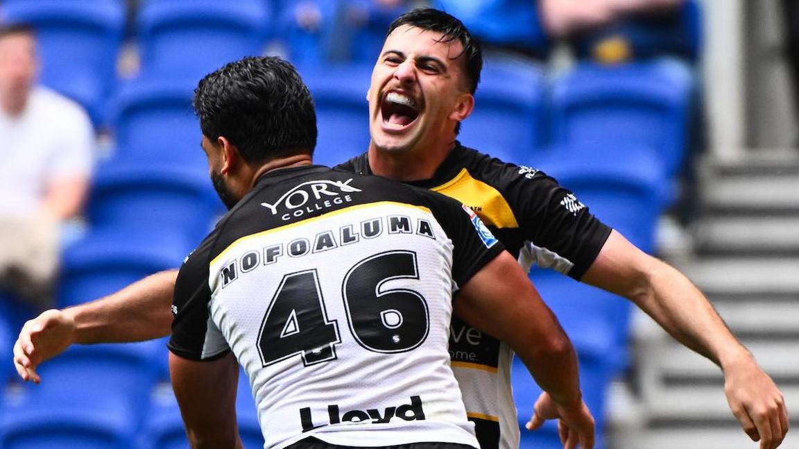 Cody Hunter of York Knights celebrating his try with team-mate David Nofoaluma.