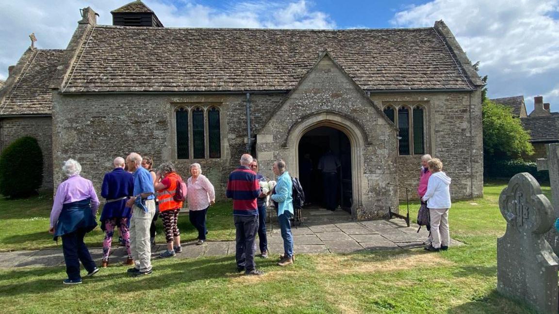 A group of walkers outside a church