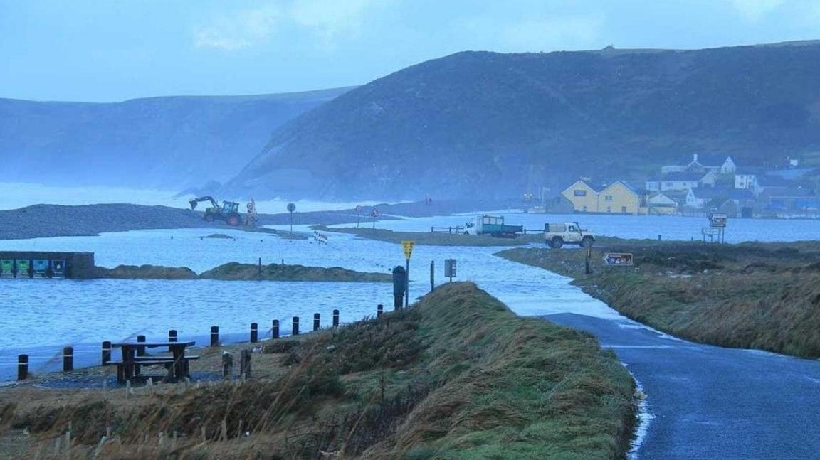 A flooded coastal road.