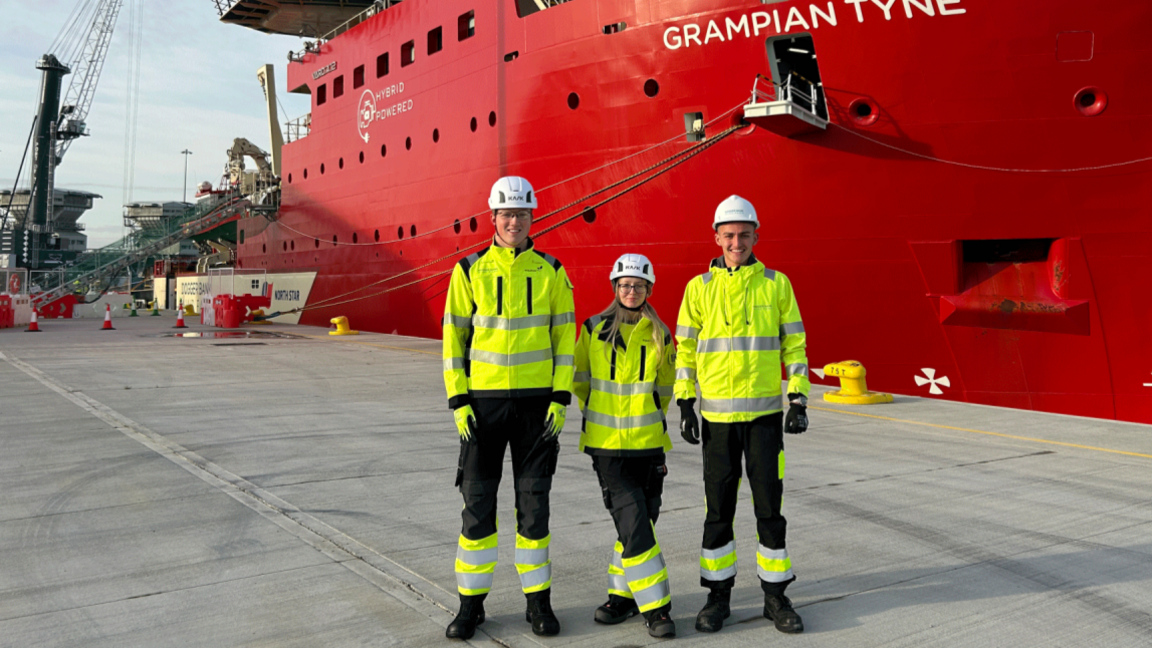 Dogger Bank apprentices next to one of the supply vessels for the windfarm