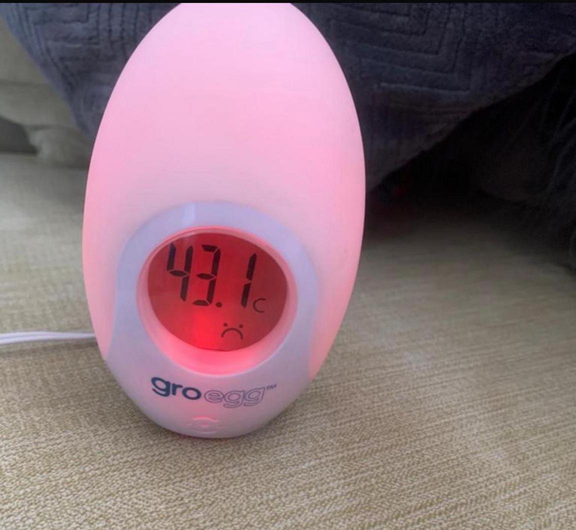 A pink temperature gauge measuring 43 degrees in a house