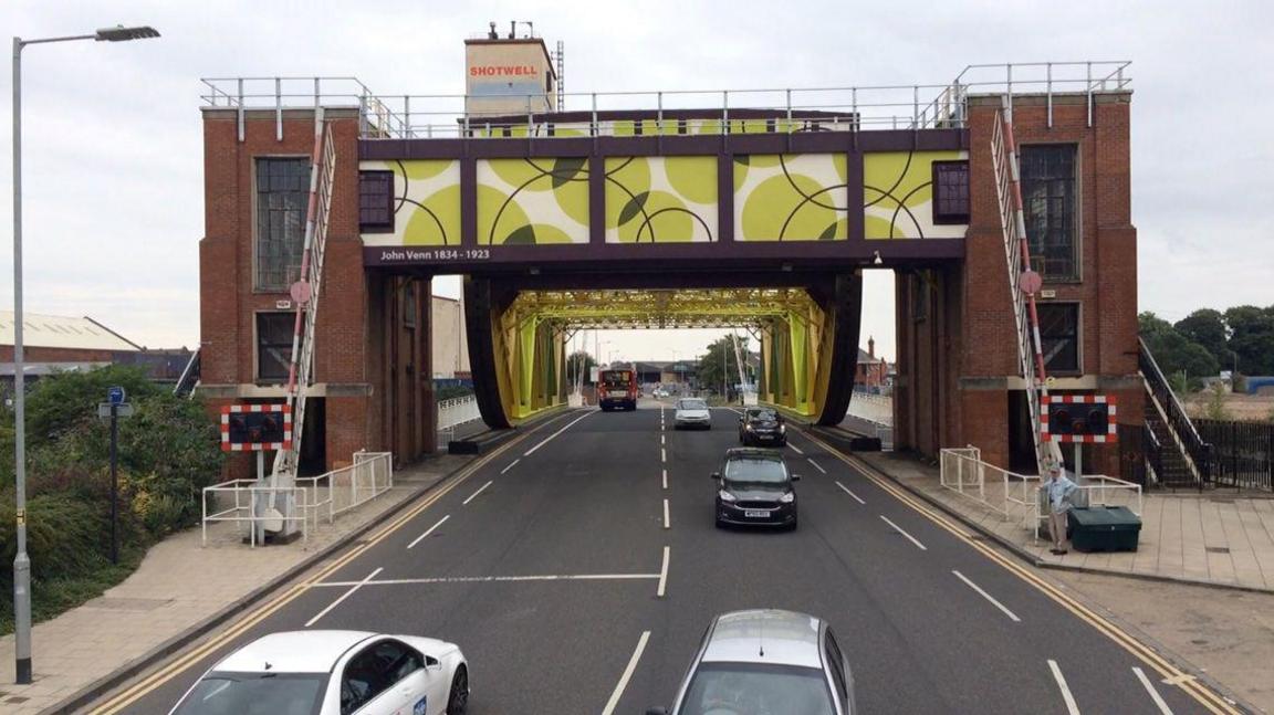 A front-facing shot of Drypool Bridge in Hull. It shows cars crossing the bridge which features a green pattern.