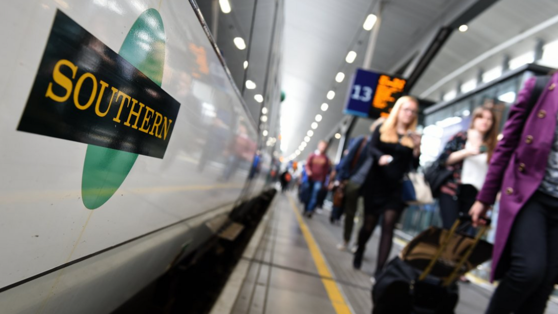 File image showing passengers walking along platform 13 with luggage at London Bridge alongside a Southern train