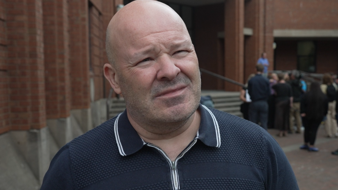 Nigel Hotham lasting extracurricular Hull Crown Court. He has a shaven caput and is wearing a bluish and achromatic polo shirt.