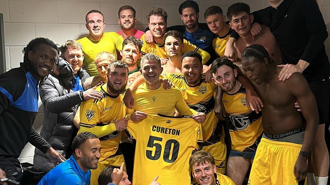 Jamie Cureton celebrates the achievement with his Kings Park Rangers teammates