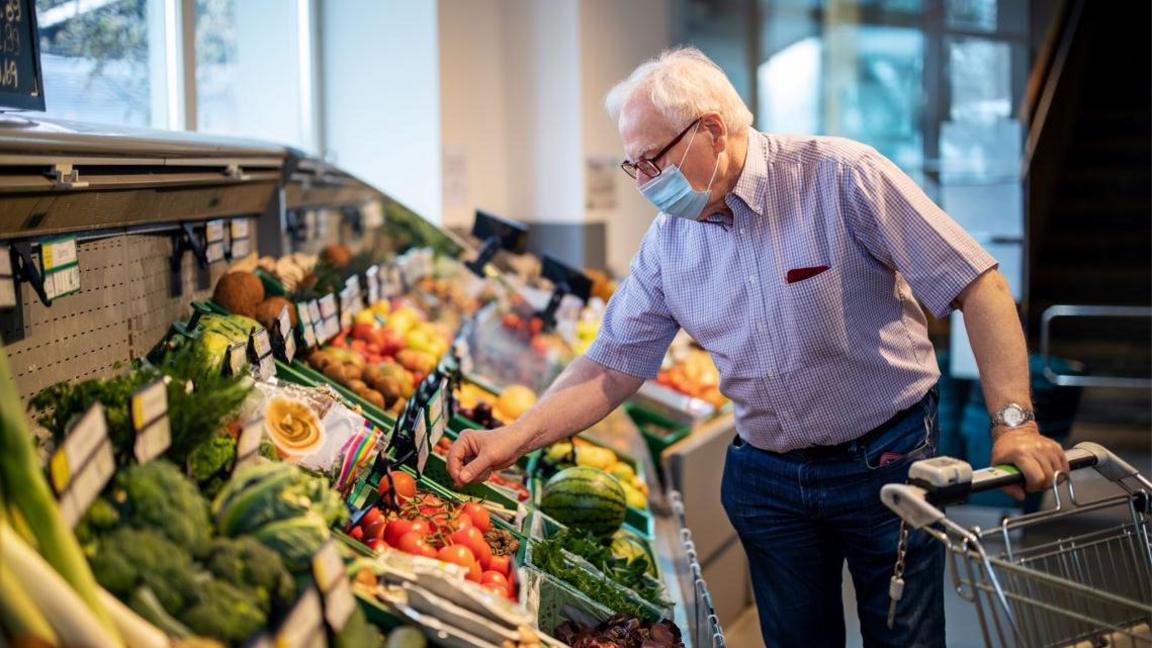 Man in mask in shop